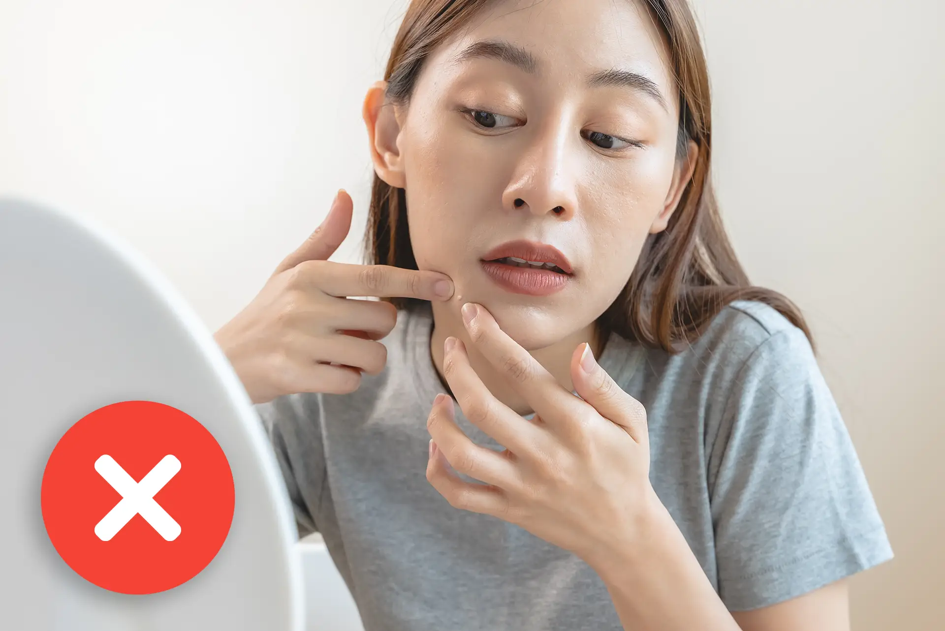 Woman trying to remove skin tag